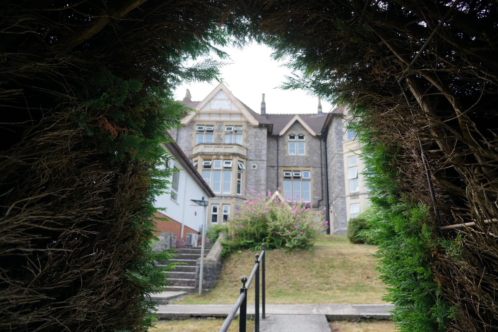 View of Broadway Lodge from arch in the garden