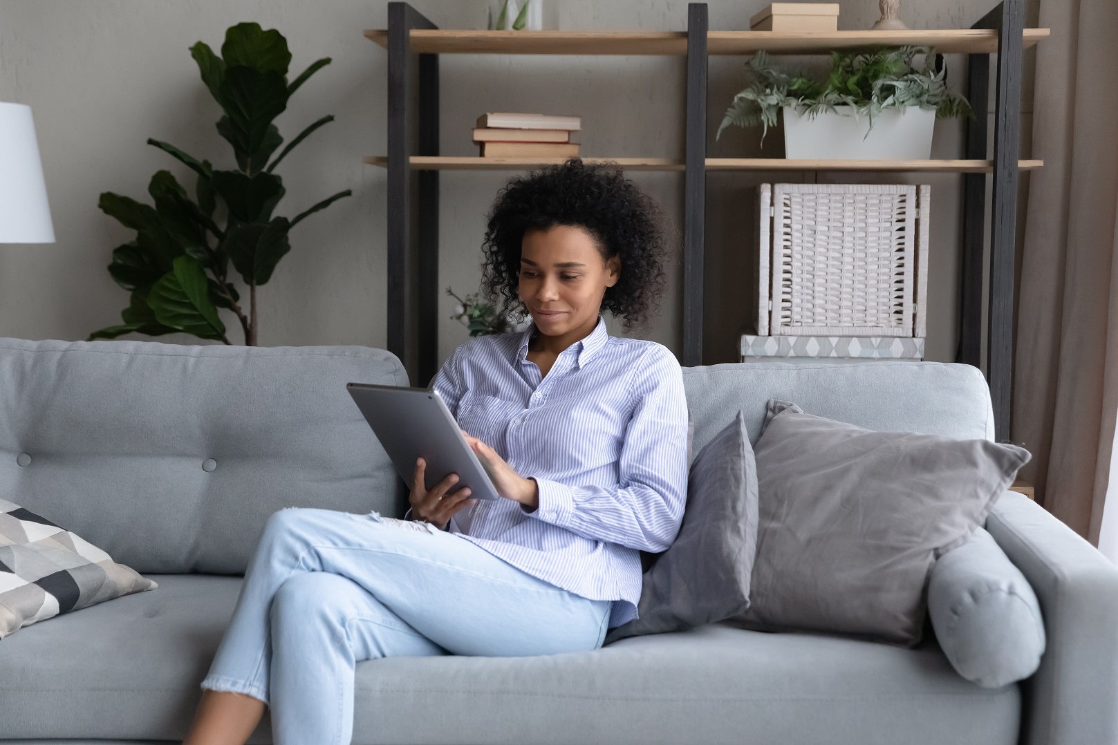 Lady looking at an IPad in lounge