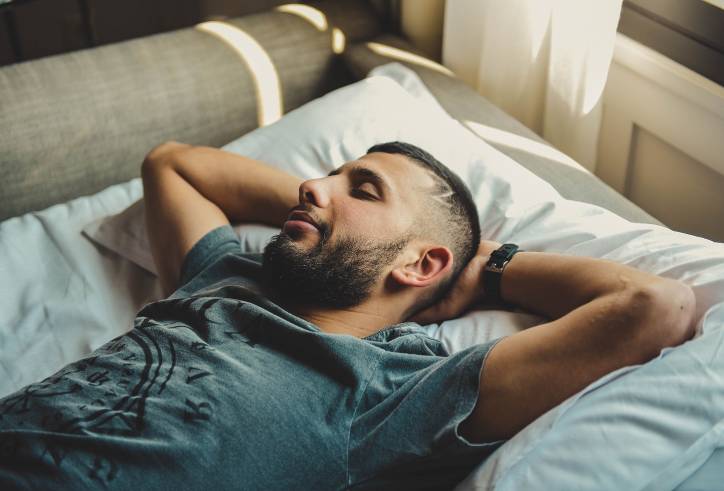 Man on sofa with eyes shut