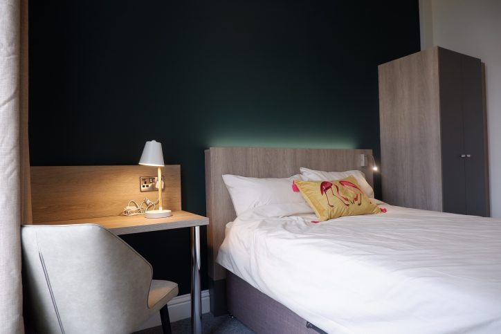 Double bed with desk and a chair
