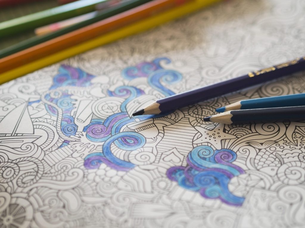 a pattern in a book coloured in blue and purple pencil