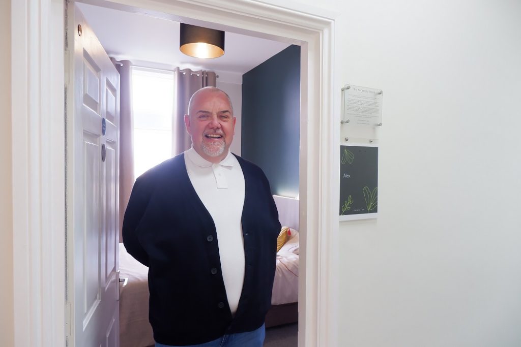 John stood in a bedroom doorway